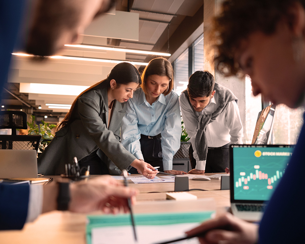 People in a meeting reviewing quarterly results