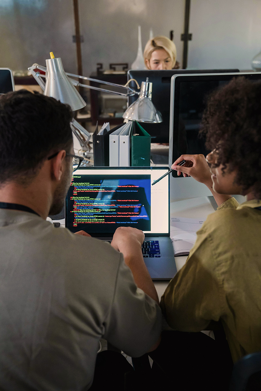 Man and woman discussing project on their Mac
