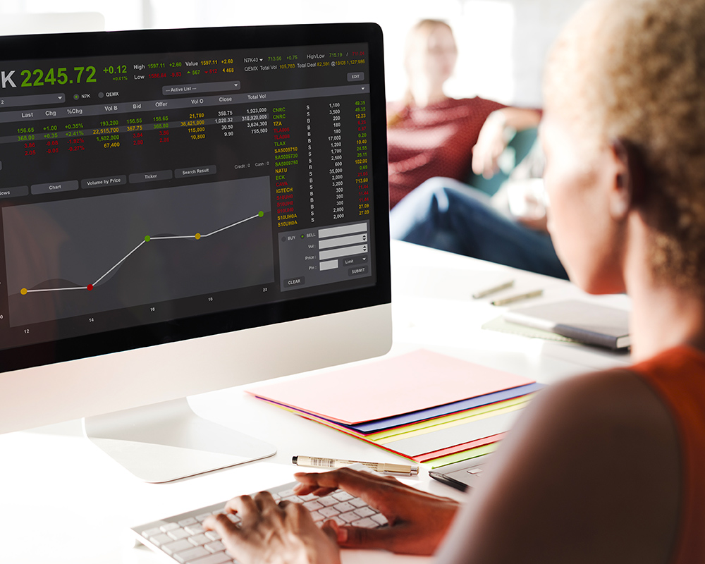 Woman looking at the stock market performance on her iMac