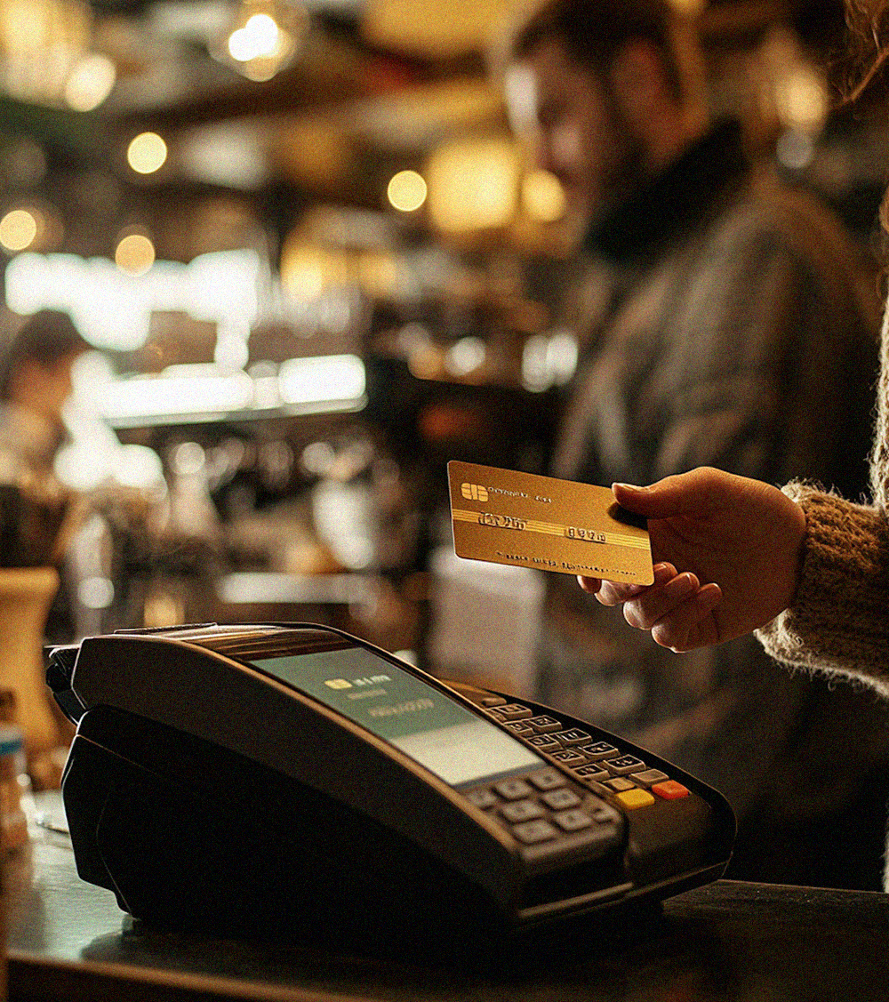 Woman sliding credit card on a posnet terminal