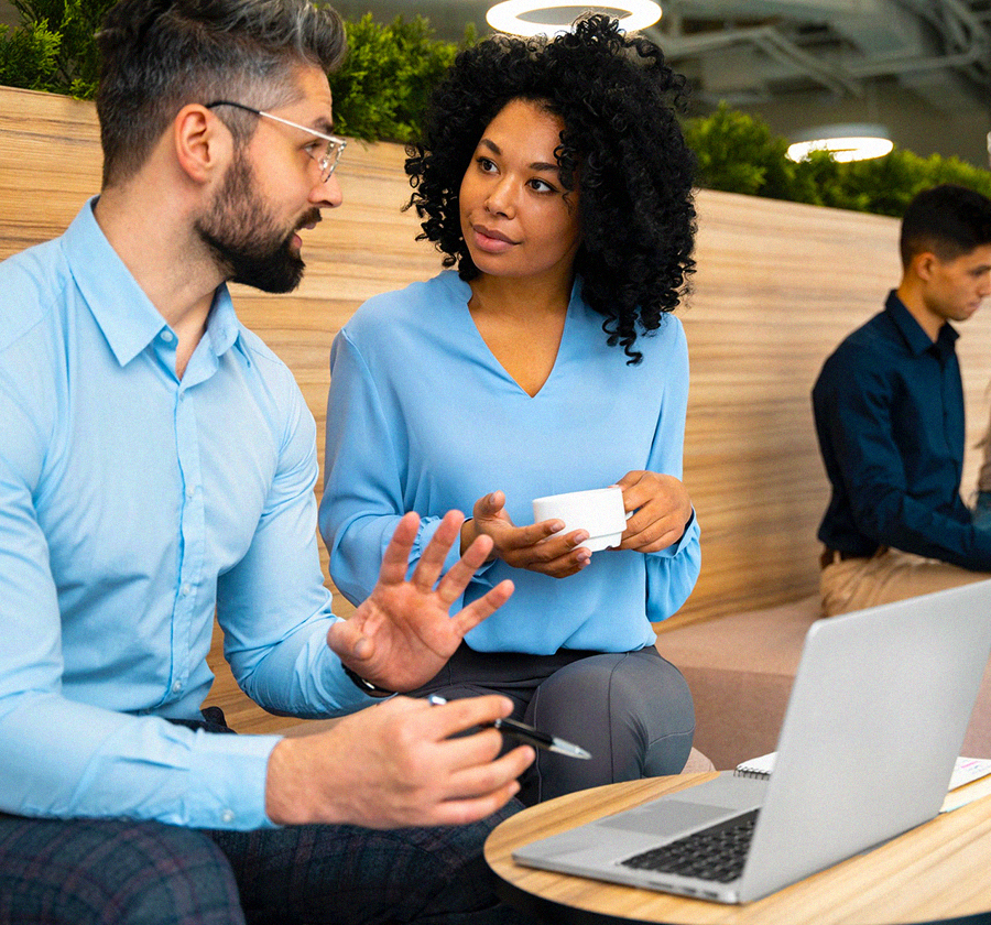 Bank executive showing his customer a portfolio package on his Mac