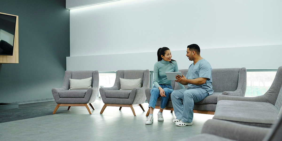 Doctor talking to a patient and showing details on his iPad