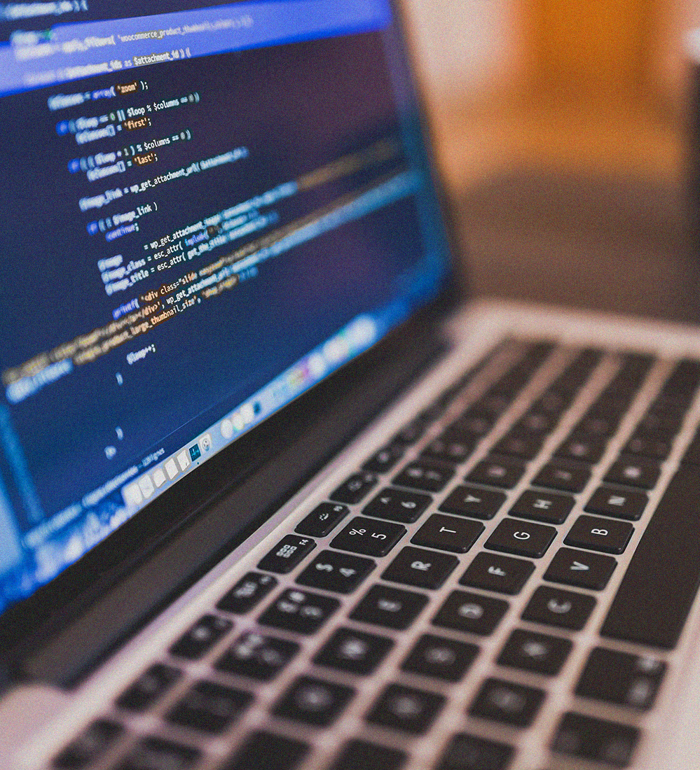 MacBook computer showing Apple Xcode and some code