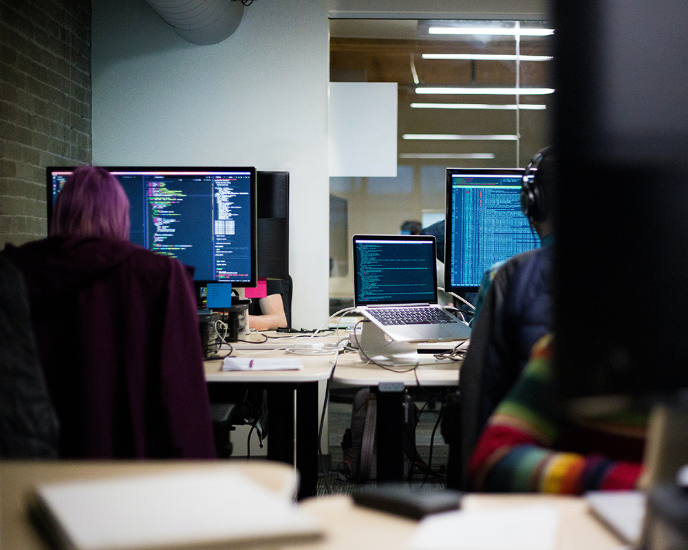 Developers coding on their Mac computers